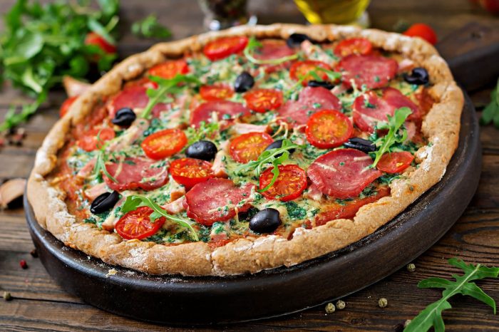 Vegan pizza with tomatoes, olives, and veggies