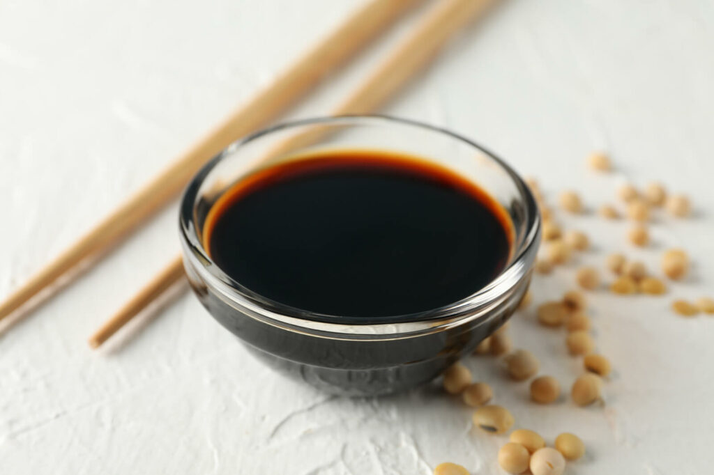 Soy sauce in glass bowl with chopsticks