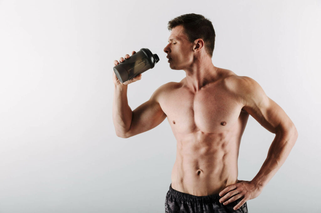 Bodybuilder drinking protein